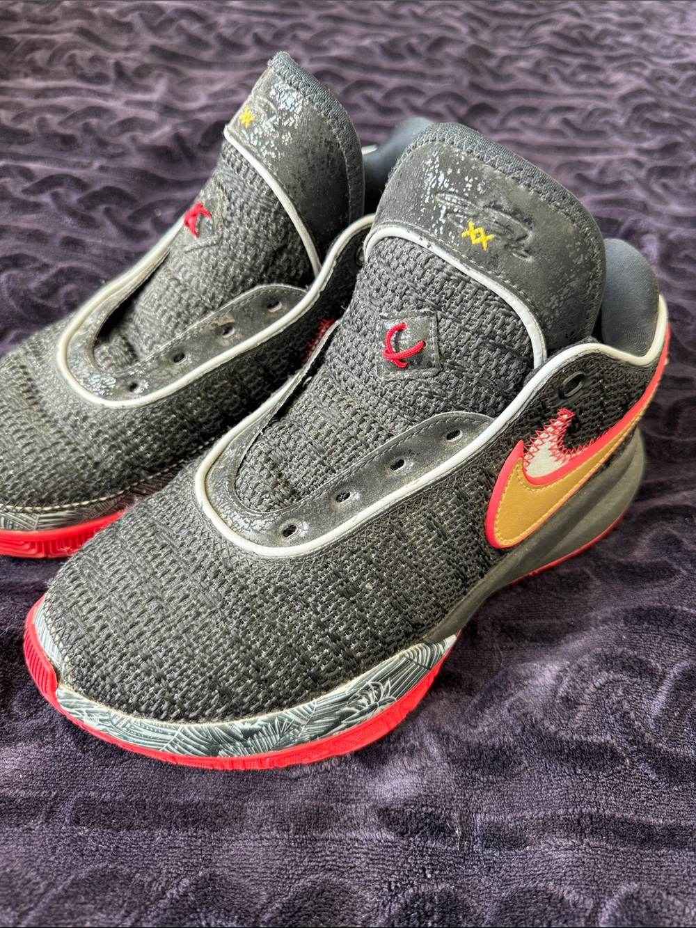 Nike Kids Black Knit Sneakers with Gold and Red Accents
